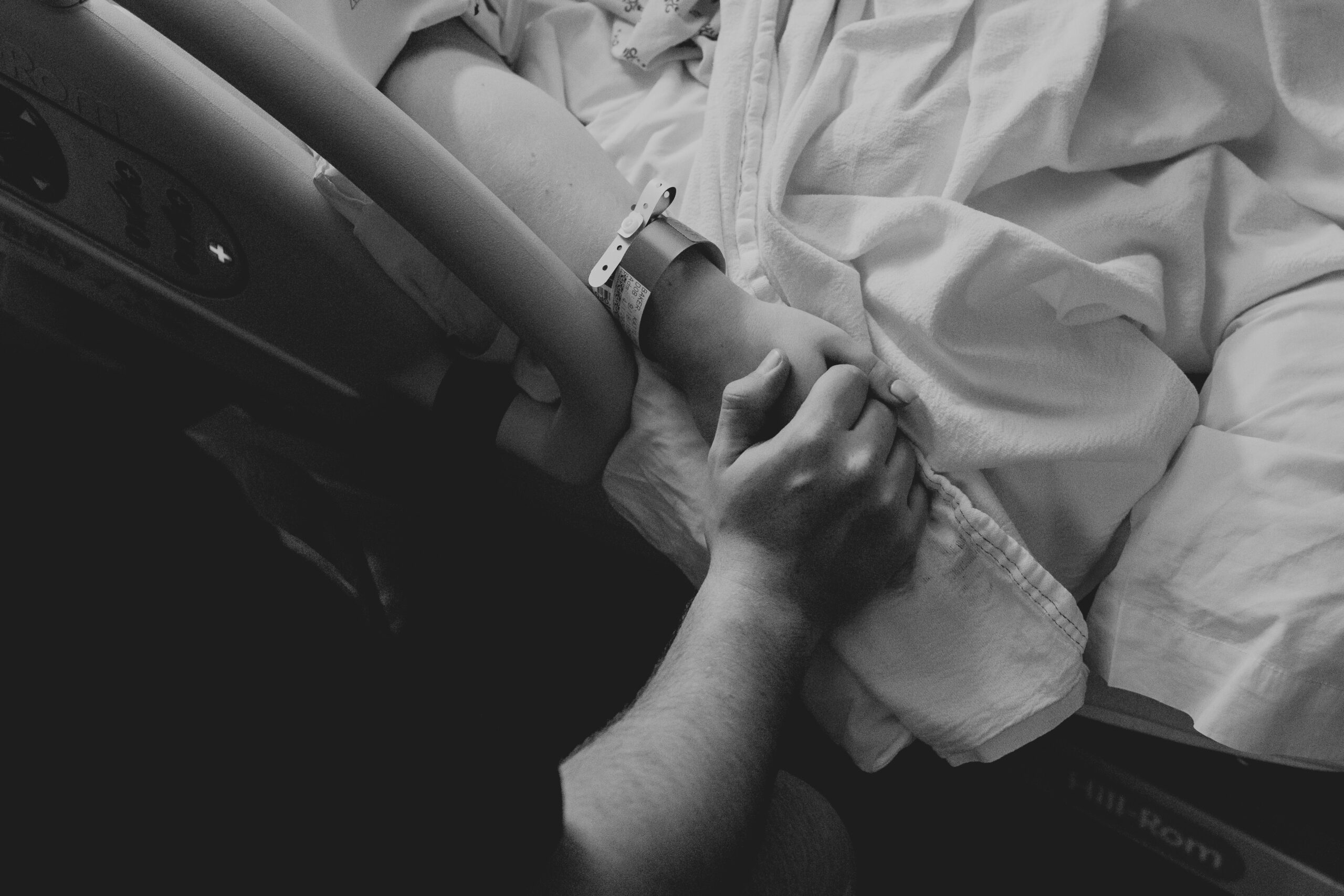 western montana hospital birth black and white dad holding mom hand