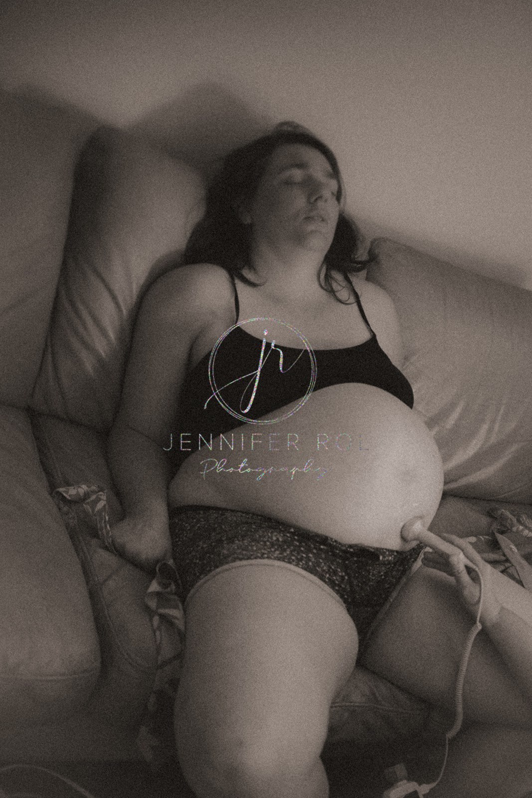 A pregnant woman in labor receives an ultrasound on a couch from Missoula Midwives