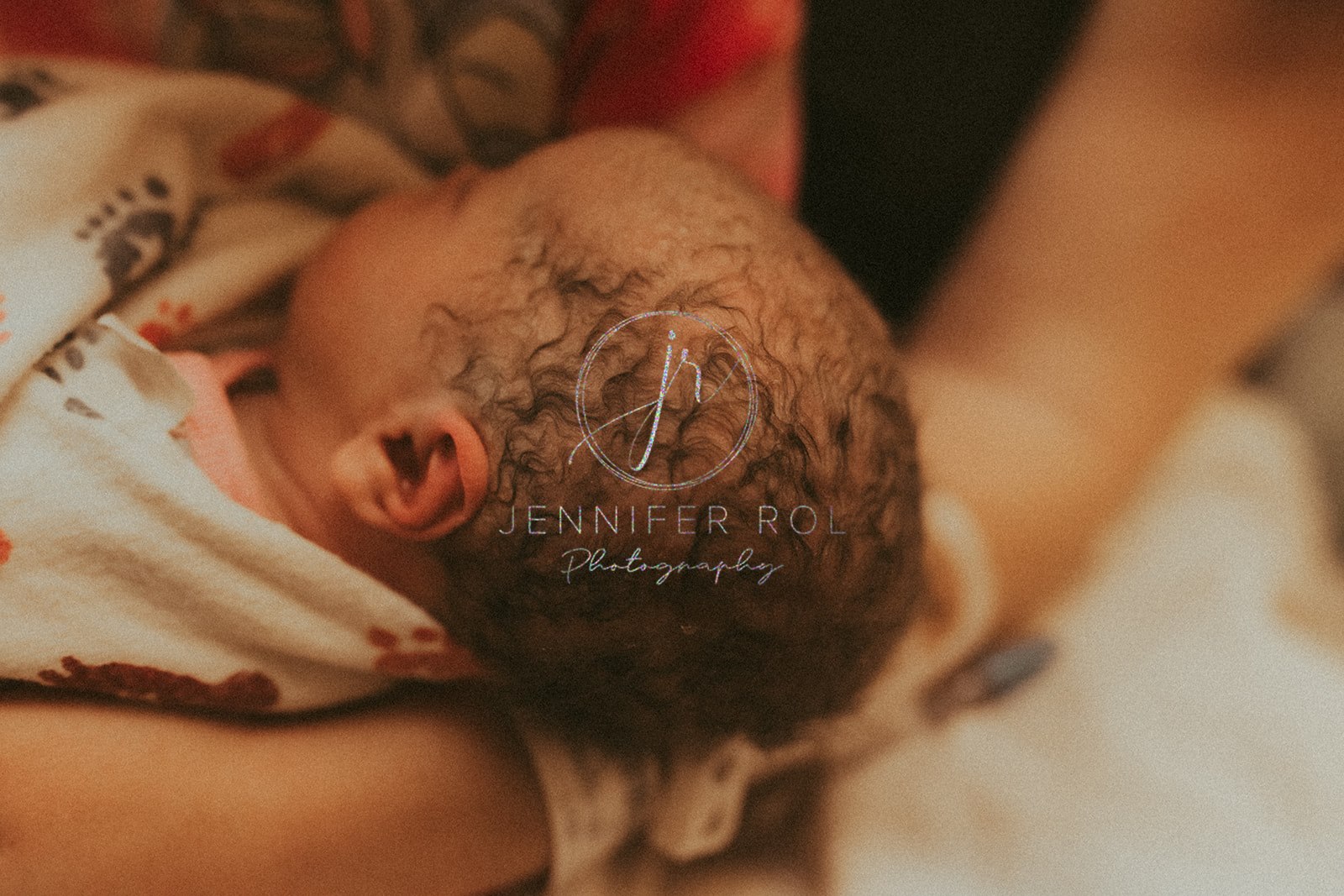 Details of a newborn baby's head while wrapped in a swaddle after meeting Nursing Nook Missoula