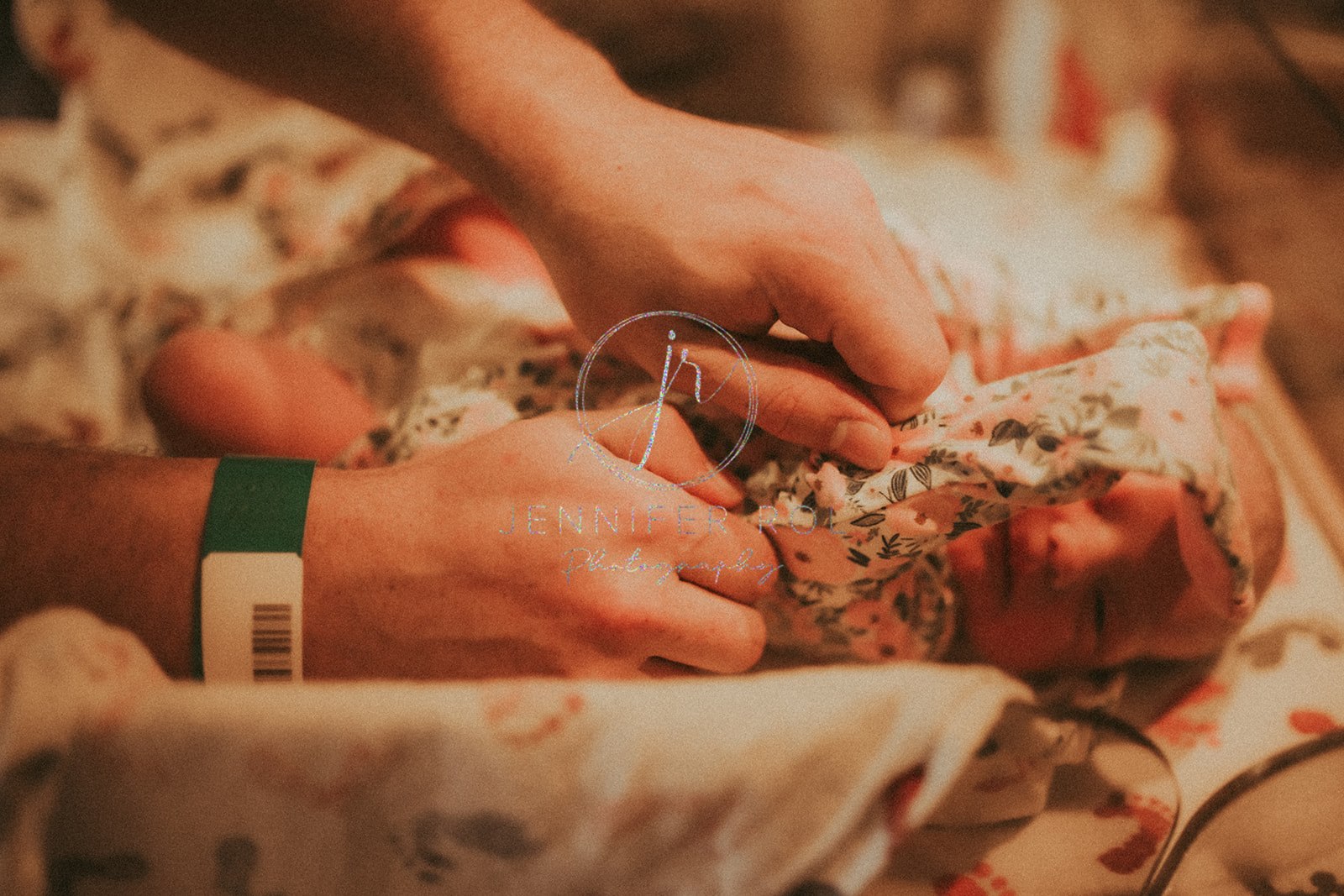 A new parent puts a onesie on their newborn baby after meeting with Nursing Nook Missoula