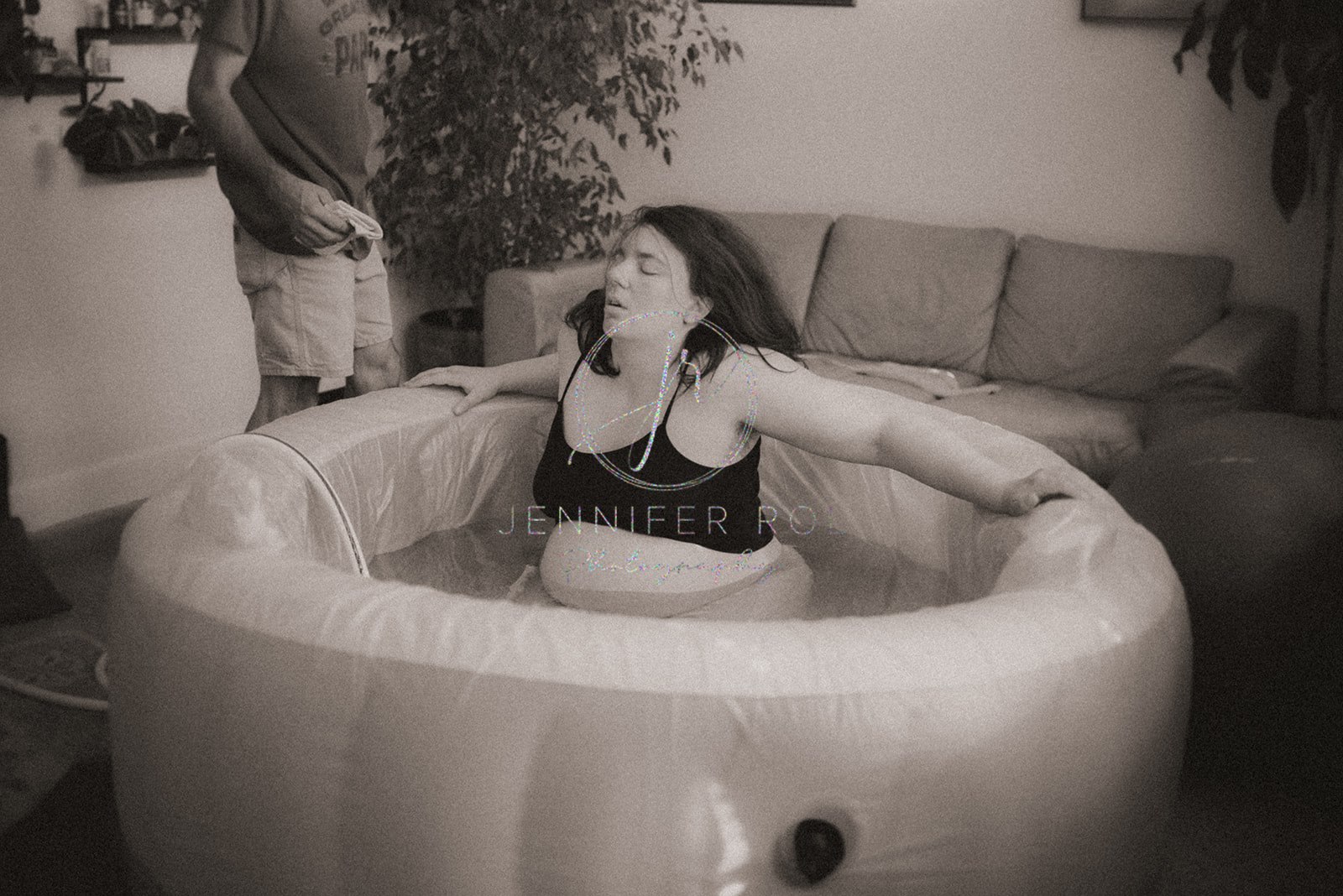 A mom to be in labor sits in her birthing tub after a prenatal massage in Missoula