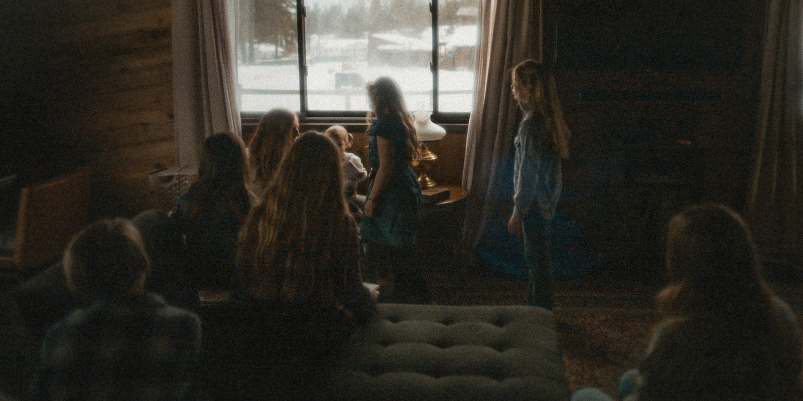 A large family of kids play in a living room together around the baby before visiting the Western Montana Fair