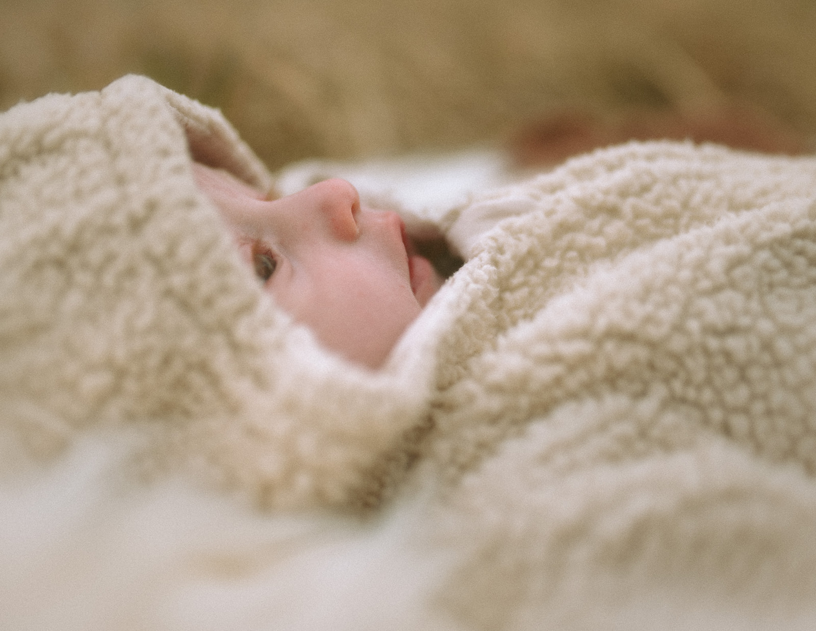 Details of a newborn laying in a cozy sweater after visiting daycares in Hamilton, MT