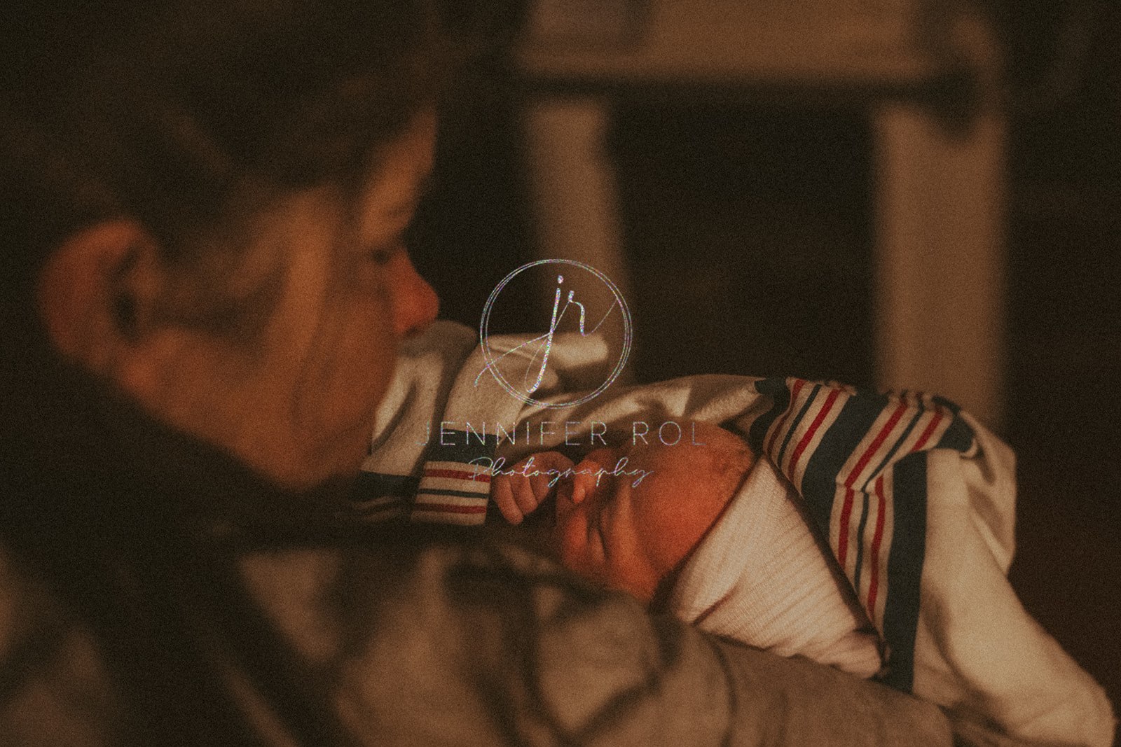 A new mother snuggles her sleeping newborn after birth supported by a midwife in Hamilton, MT
