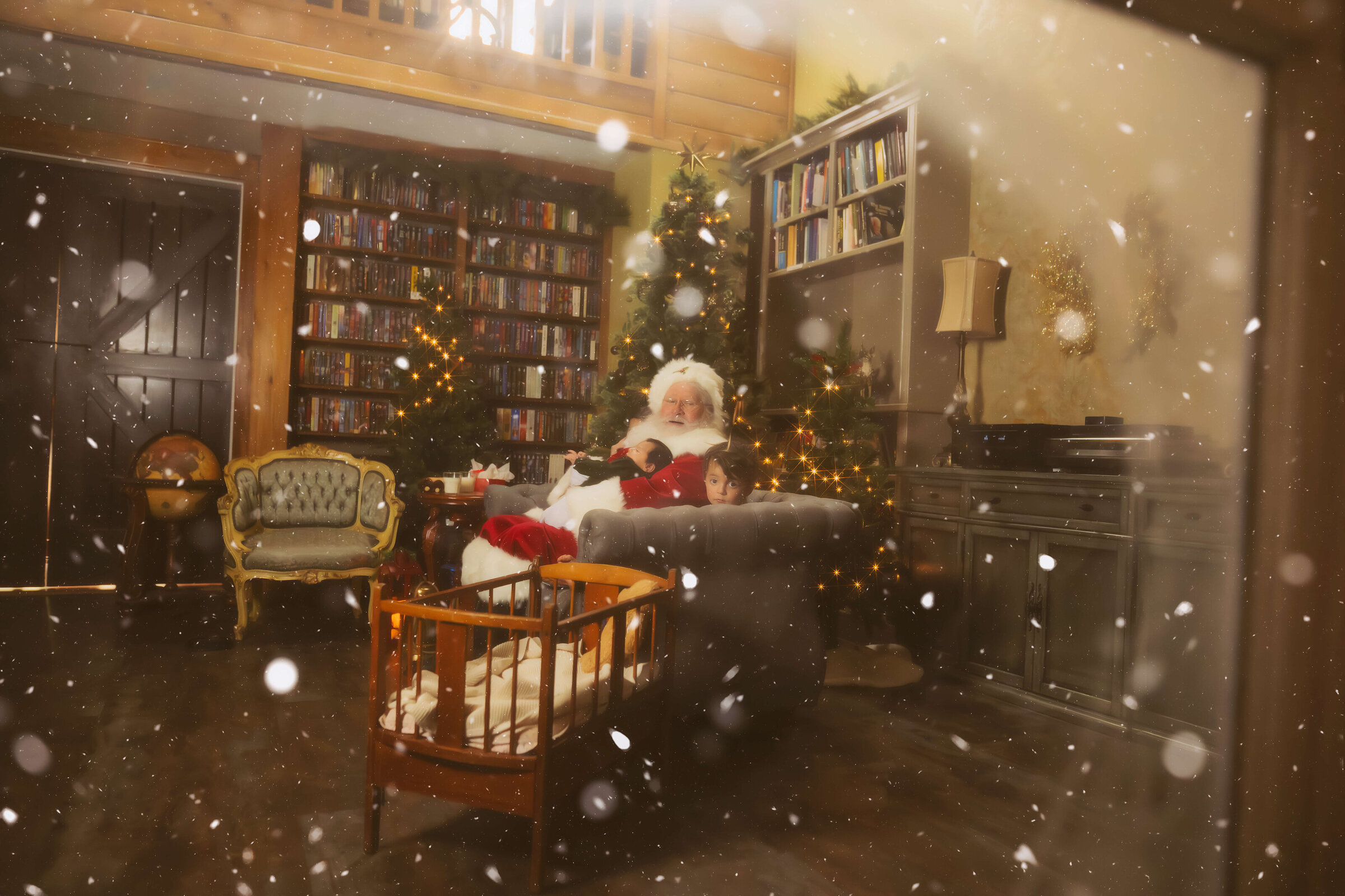 A look through a window of a young bow sitting on a couch with santa holding his baby brother