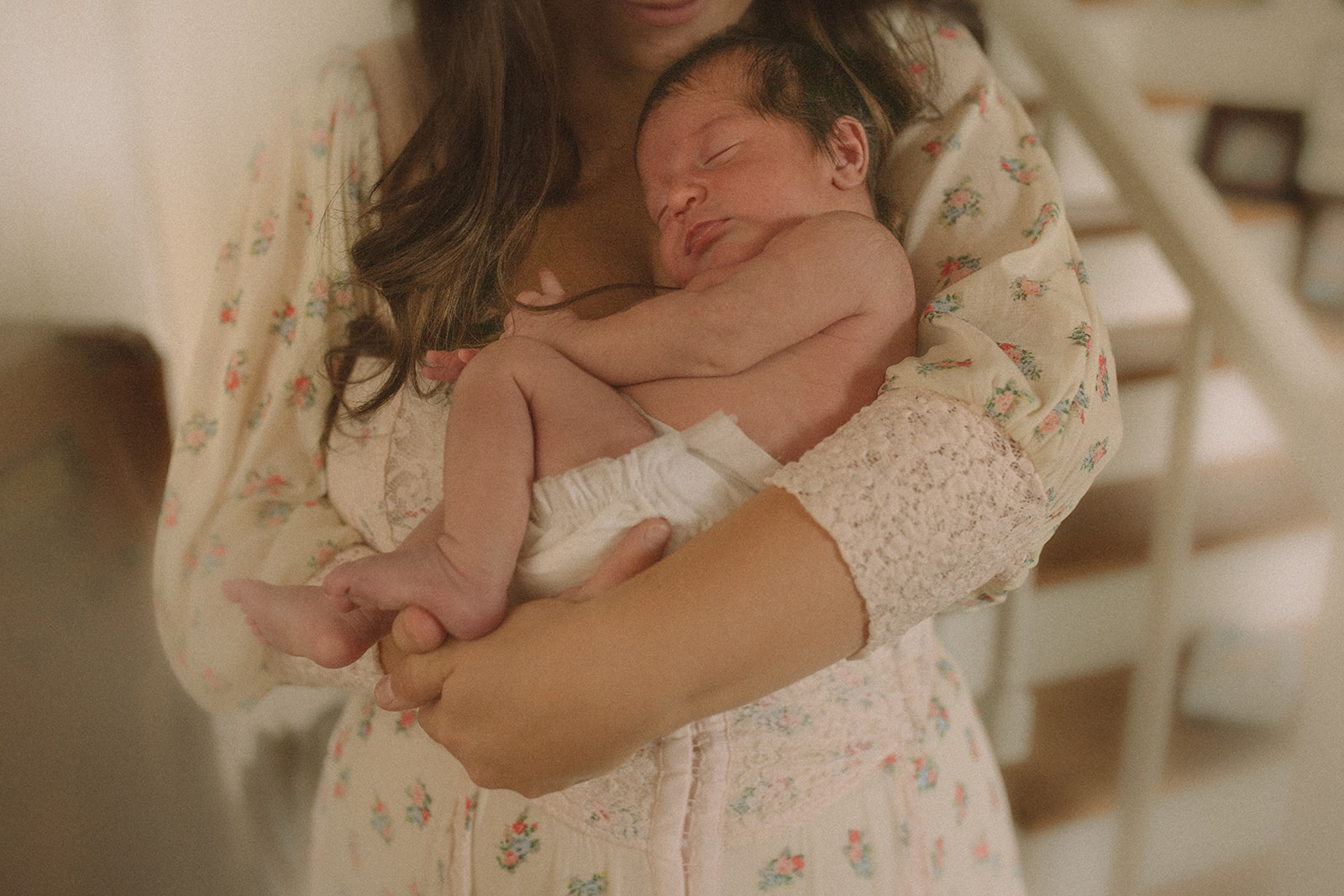 a newborn baby sleeps in a diaper against mom's chest before visiting pediatric dentists in Polson, MT