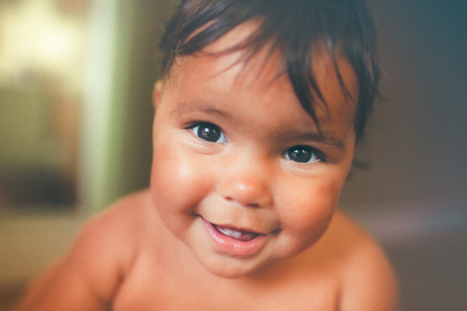 A closeup of a happy baby with no shirt before visiting preschools in polson mt