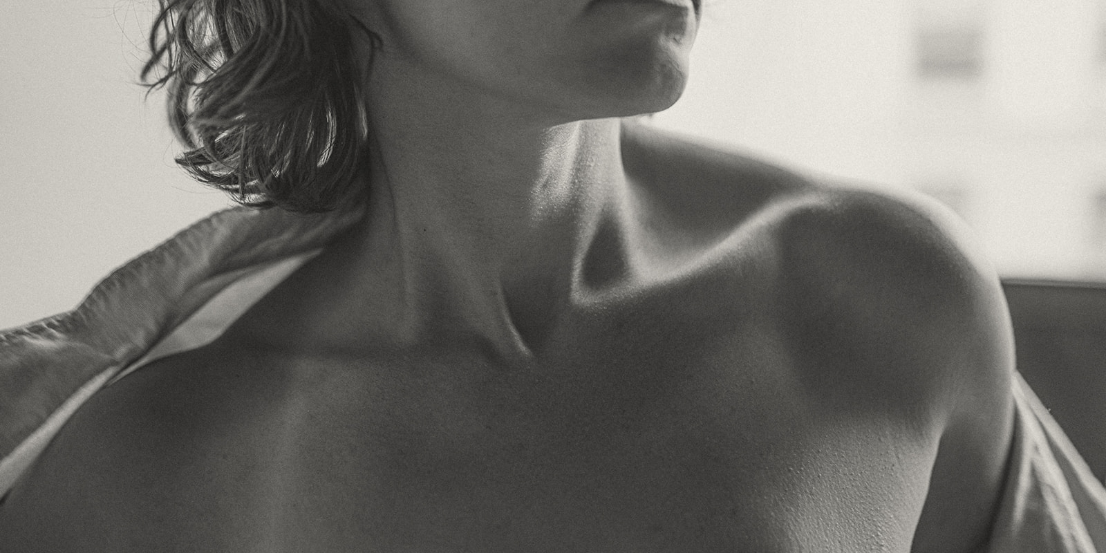 Details of the collar bones and shoulders of a woman pulling off her shirt after visiting Medical Spas in Missoula